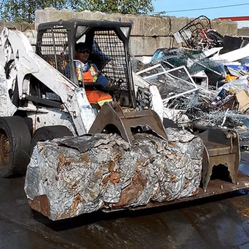 bobcat moving a large piece of metal