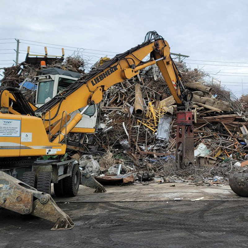excavator moving scap metal